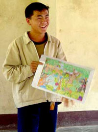 A Lao boy holding his art contest winning entry
