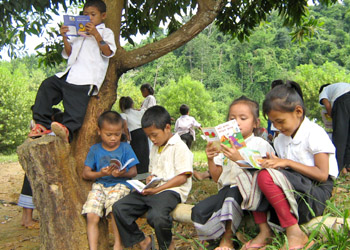 Lao schoolchildren reading, after they get their first book