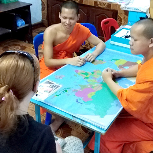 Two Lao monks talk with a woman