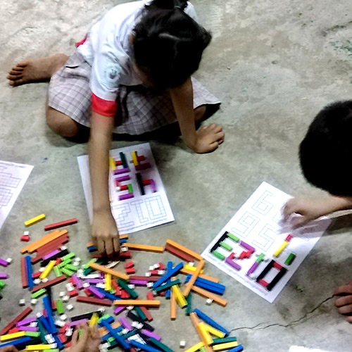 Lao schoolchildren use colored cuisenaire rods to make number shapes