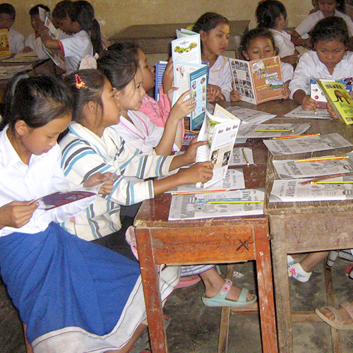 Girls in a Lao classroom reading books