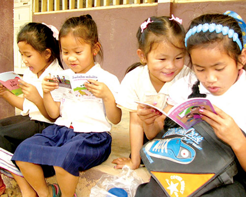 four small Lao girls reading