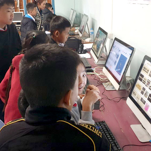 Students at a Lao school using desktop computers