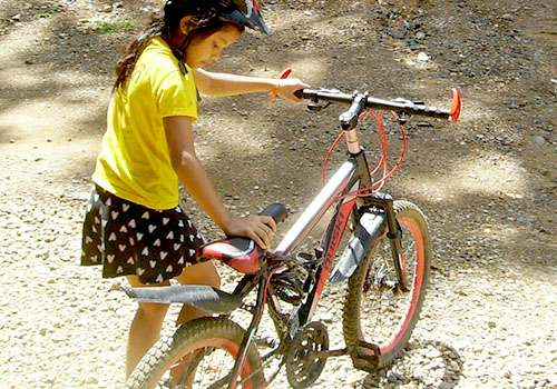 a young girl about to get on a bicycle
