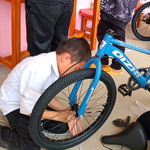 Schoolchildren assemble their school's new fleet of bicycles