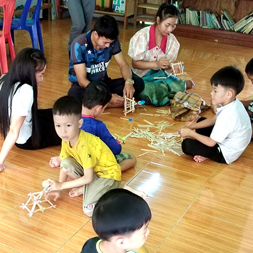At Little Bear School in Laos, teachers and students make  toy catapults from popsicle sticks and rubber bands.