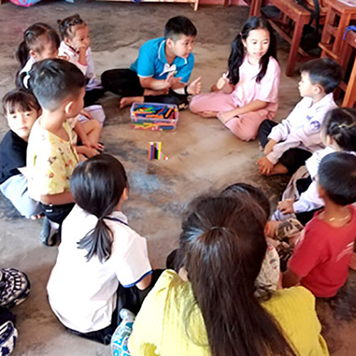 Children from Big Sister Mouse school in Luang Prabang teach about cuisenaire rods in a rural school
