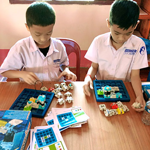 A 'Circuit Maze' puzzle makes it fun for these boys to learn the basics of electricity.