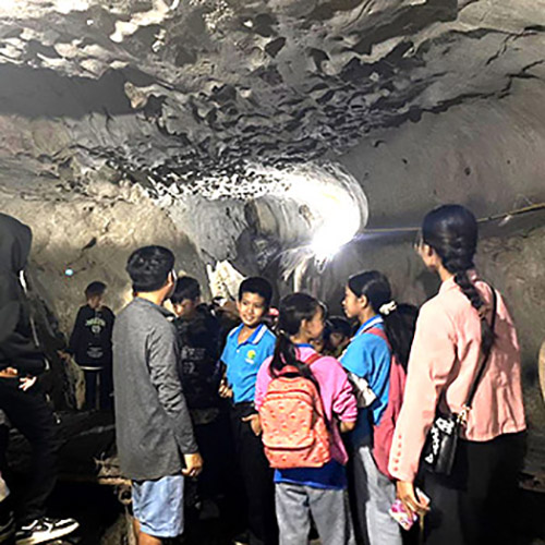 Students from Ton Kit school visit a cave in Nong Khiaw, where Lao civilians too refuge from U.S. bombing.